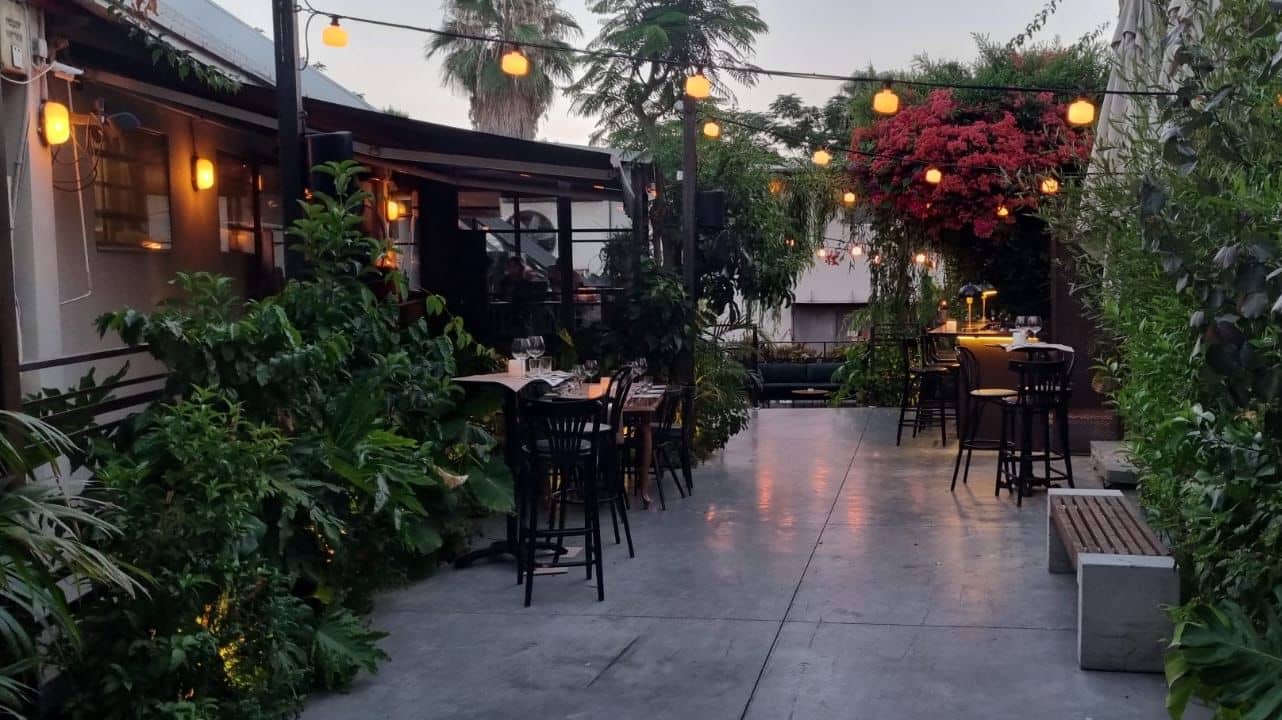 Garden dining area shown in the HaSalon reservation gallery.